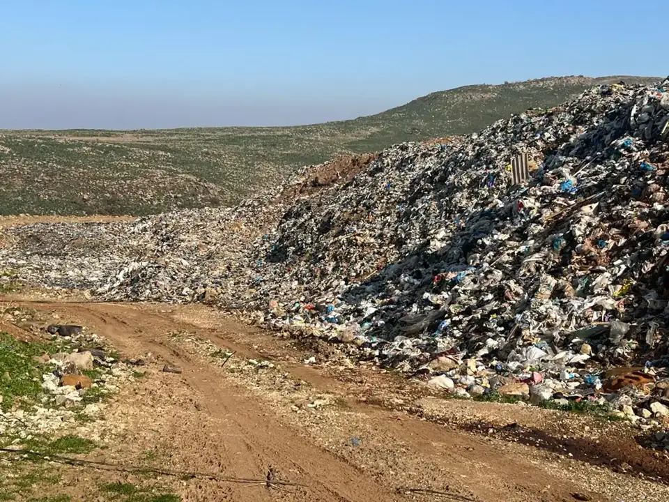 Large open waste disposal site on a hillside